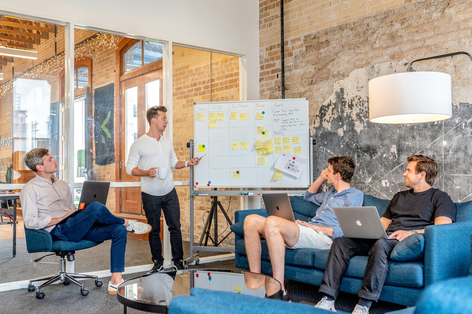 Team brainstorming at a whiteboard in a casual office